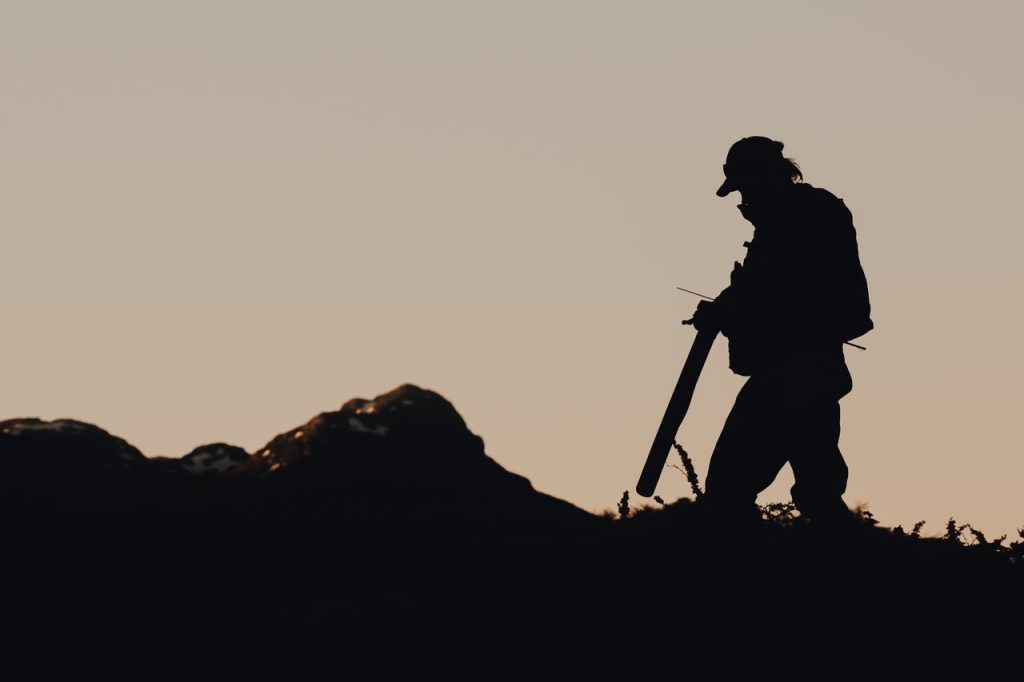 Dramatic silhouette of a hiker with gear at sunrise, capturing the essence of adventure and exploration.